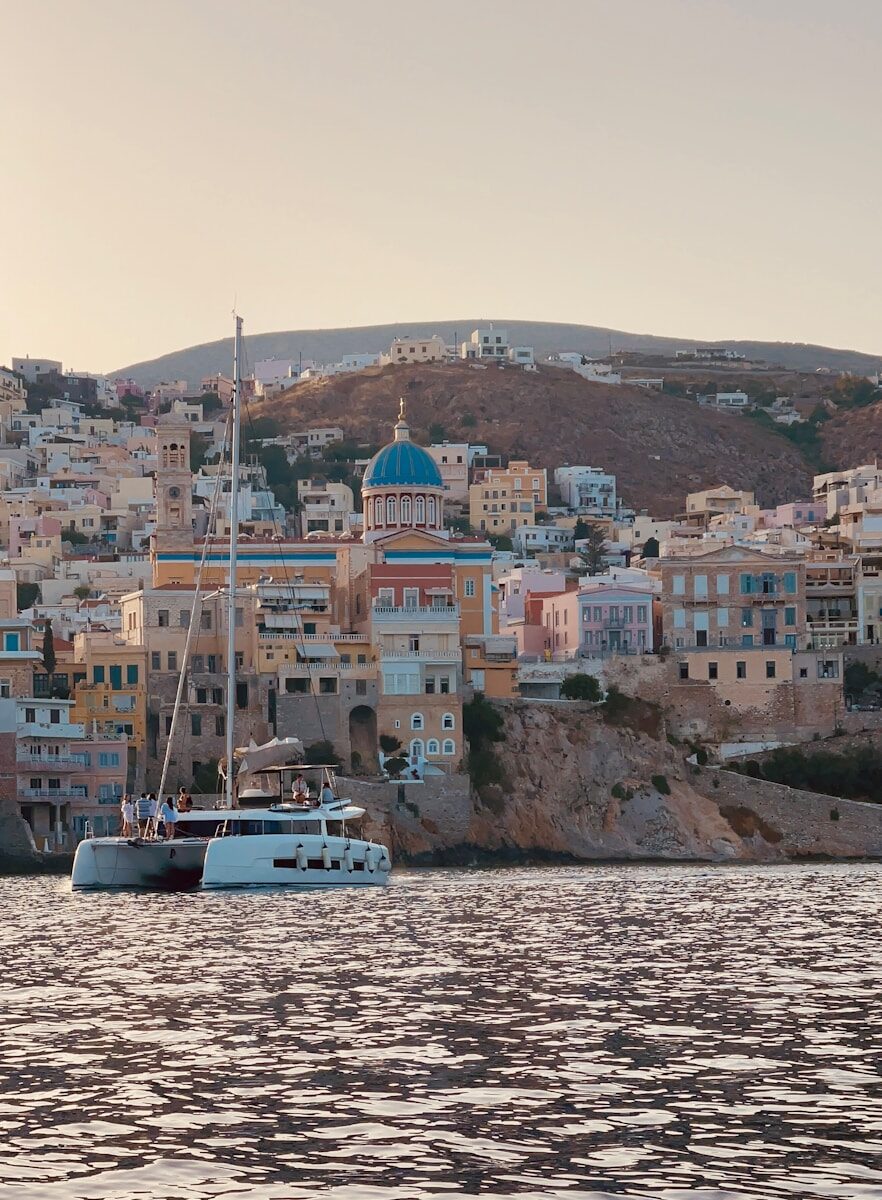a boat in a body of water near a city